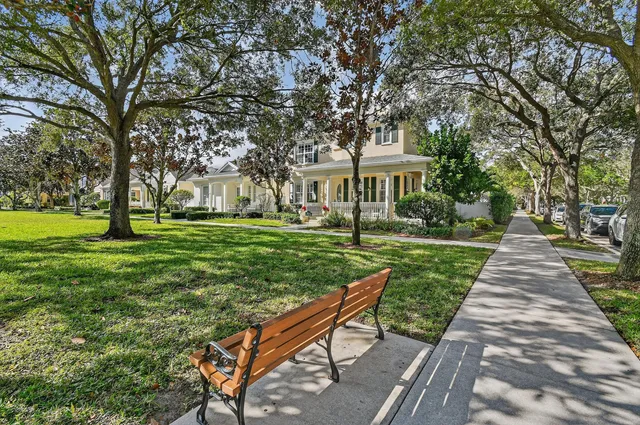 a view of a hallway with entryway closet and hall with wooden floor