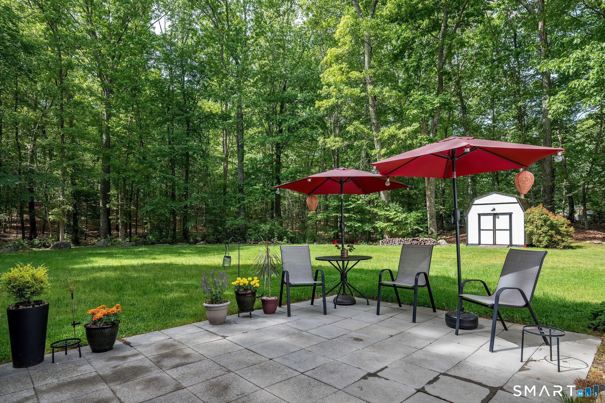 60 Bradley Corners Road Madison, CT 06443 - Photo 28 of 33 an outdoor view of a garden with an umbrella