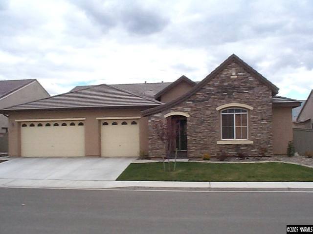 1672 Broadstone Way Reno, NV 89521 - Photo 1 of 8 a front view of a house with a yard and garage