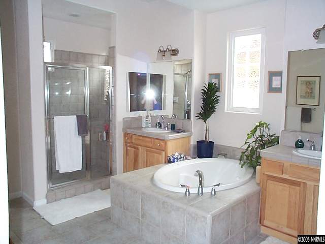 1672 Broadstone Way Reno, NV 89521 - Photo 4 of 8 a kitchen with a refrigerator and a sink