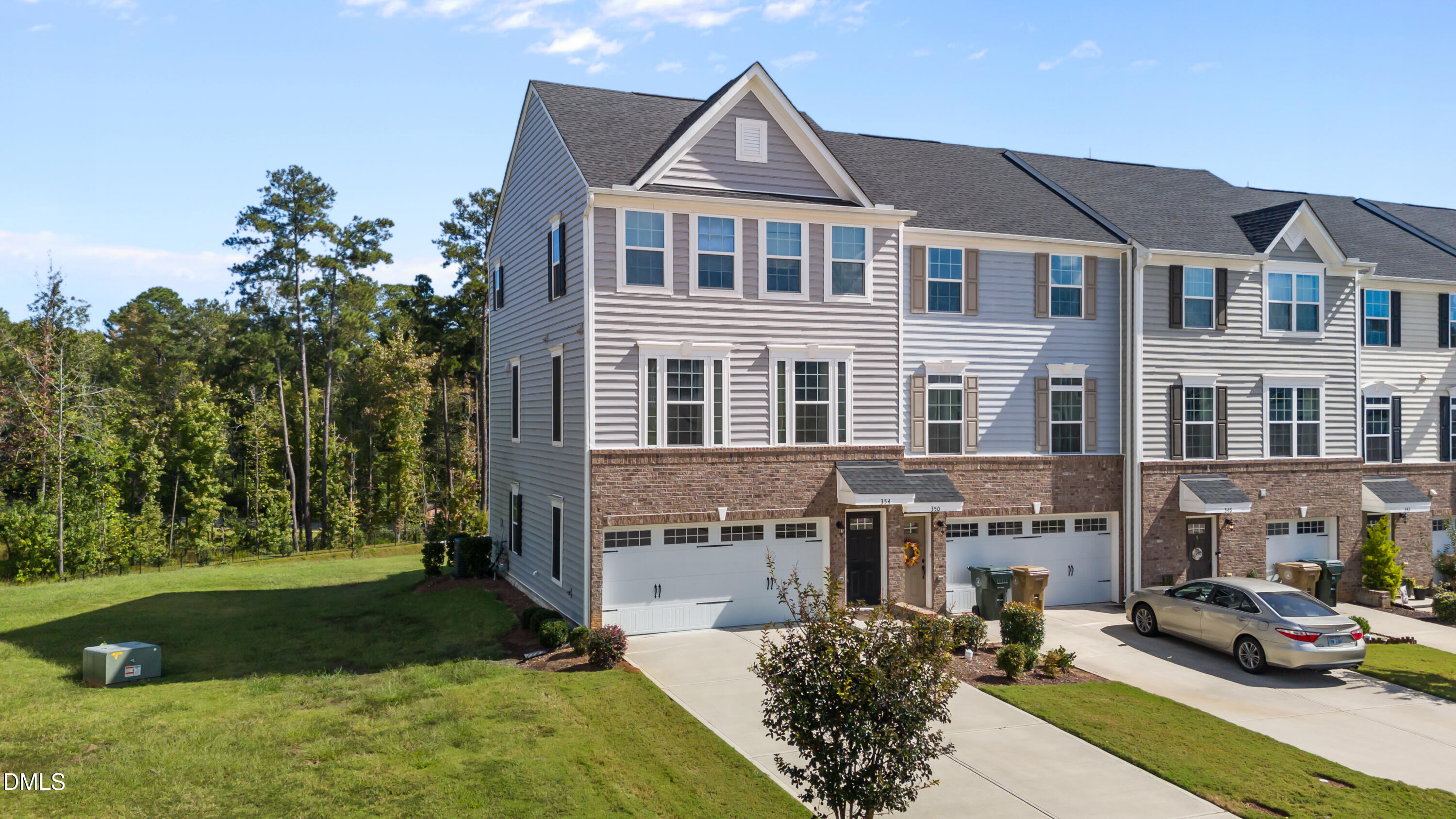 354 Amber Acorn Avenue Raleigh, NC 27603 - Photo 1 of 47 a front view of a residential apartment building with a yard