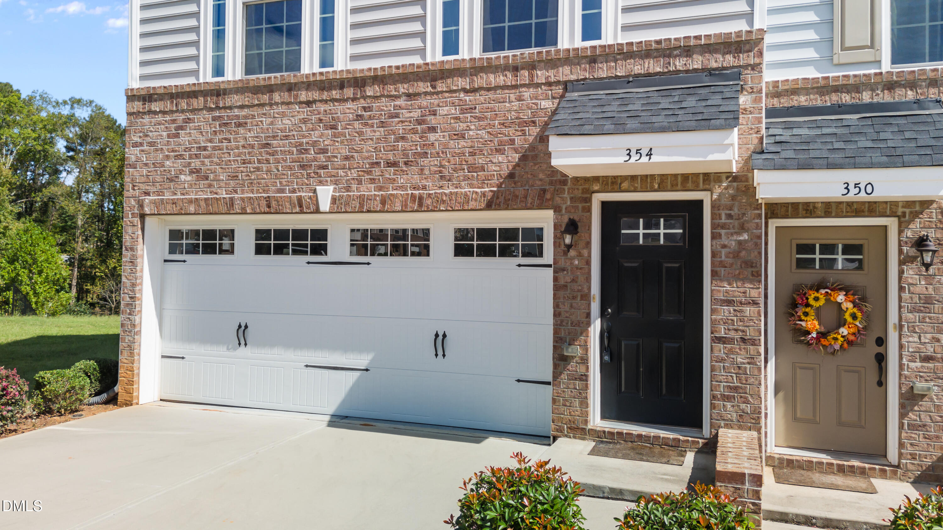 354 Amber Acorn Avenue Raleigh, NC 27603 - Photo 13 of 47 a front view of a building with glass windows and door