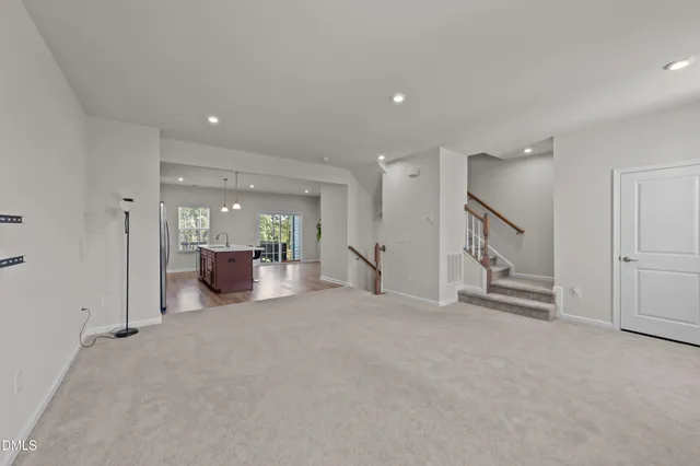 a view of a livingroom with furniture and a hallway