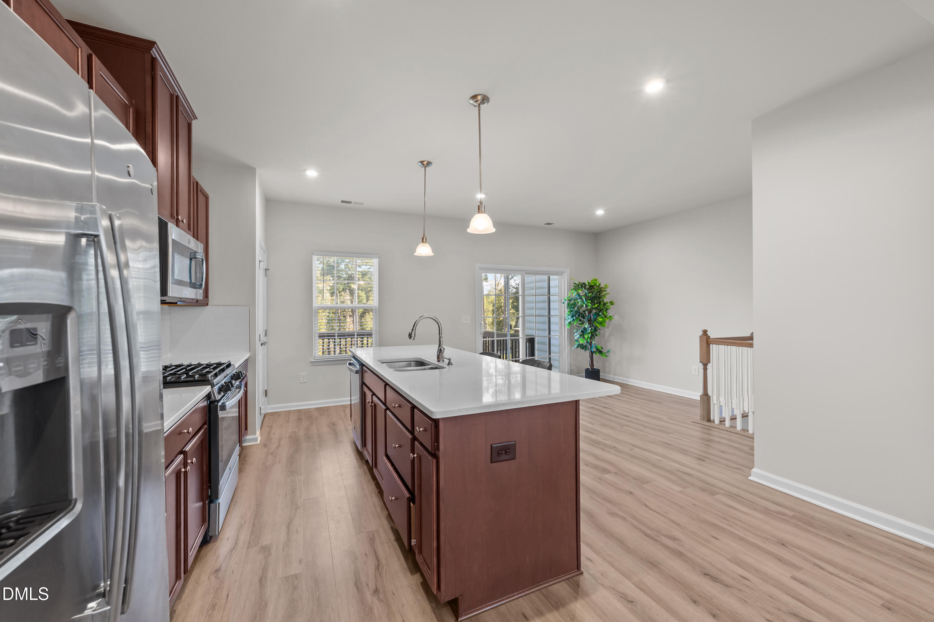 354 Amber Acorn Avenue Raleigh, NC 27603 - Photo 28 of 47 a kitchen with stainless steel appliances granite countertop a sink stove and wooden floor