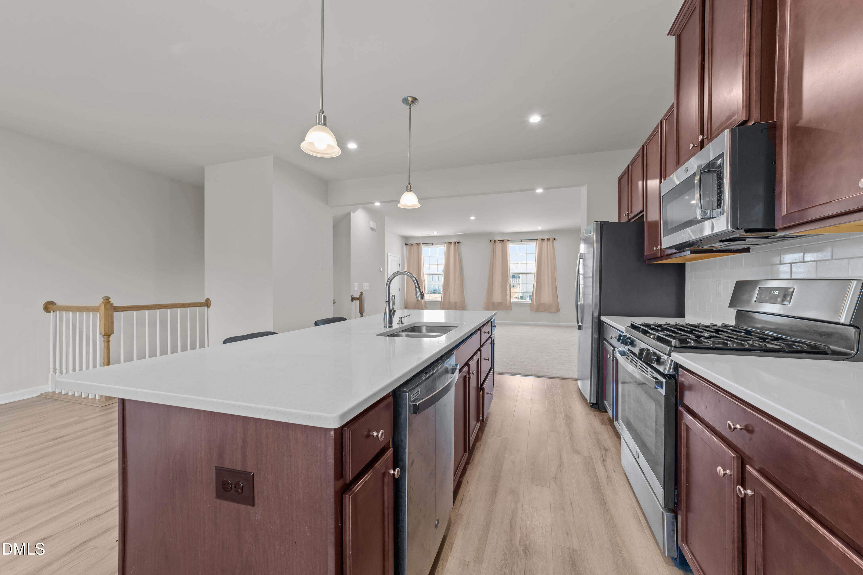 354 Amber Acorn Avenue Raleigh, NC 27603 - Photo 29 of 47 a kitchen with stainless steel appliances granite countertop a sink stove and cabinets