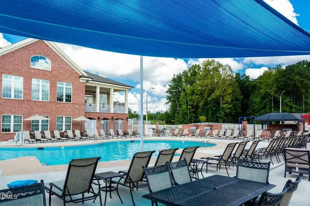 a view of a patio with table and chairs under an umbrella