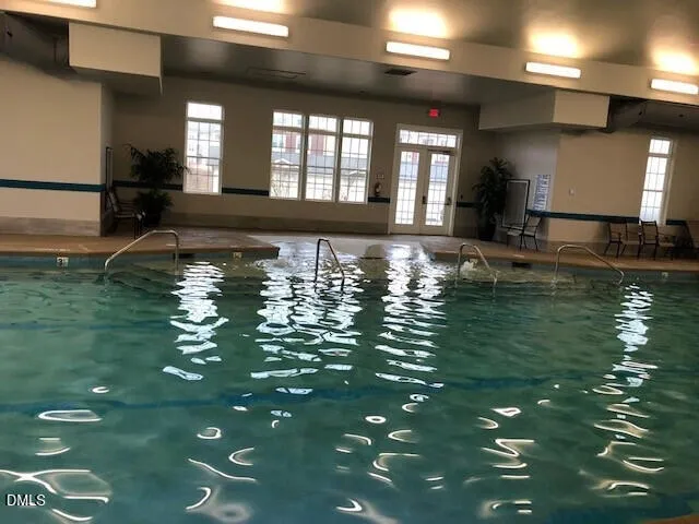 a view of a pool table and chairs in a room