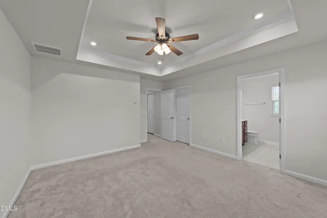 wooden floor in an empty room with a ceiling fan
