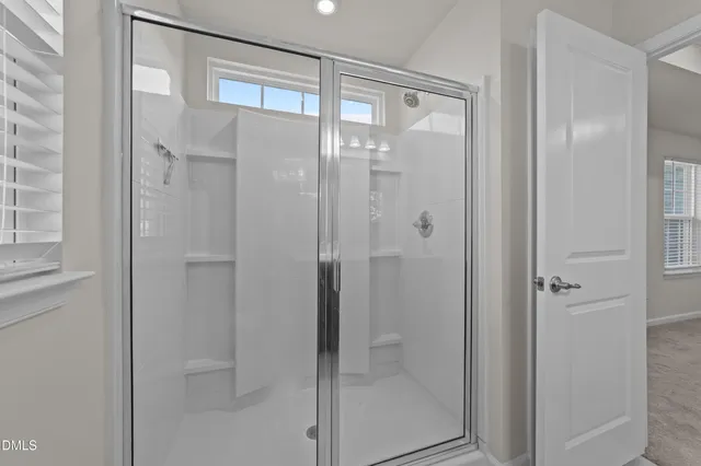 a bathroom with a glass shower door