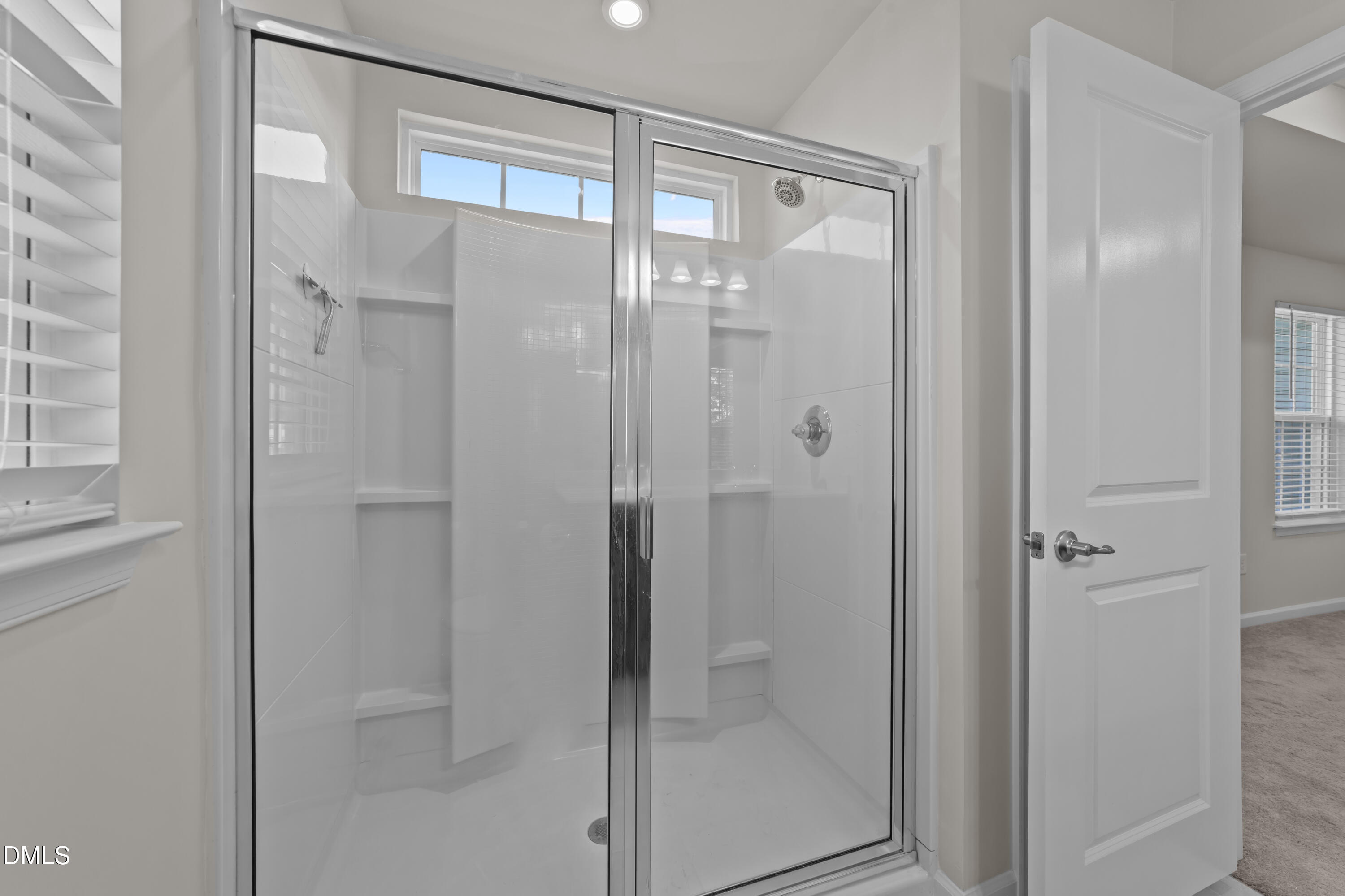 354 Amber Acorn Avenue Raleigh, NC 27603 - Photo 41 of 47 a bathroom with a glass shower door