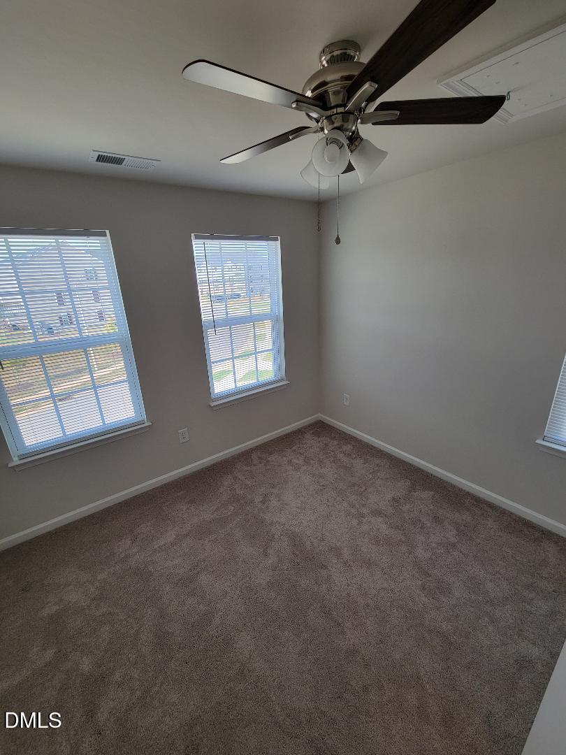 354 Amber Acorn Avenue Raleigh, NC 27603 - Photo 44 of 47 an empty room with windows and fan
