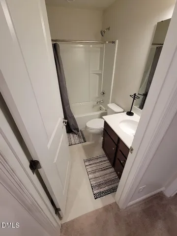 a bathroom with a sink a toilet a toilet and a window