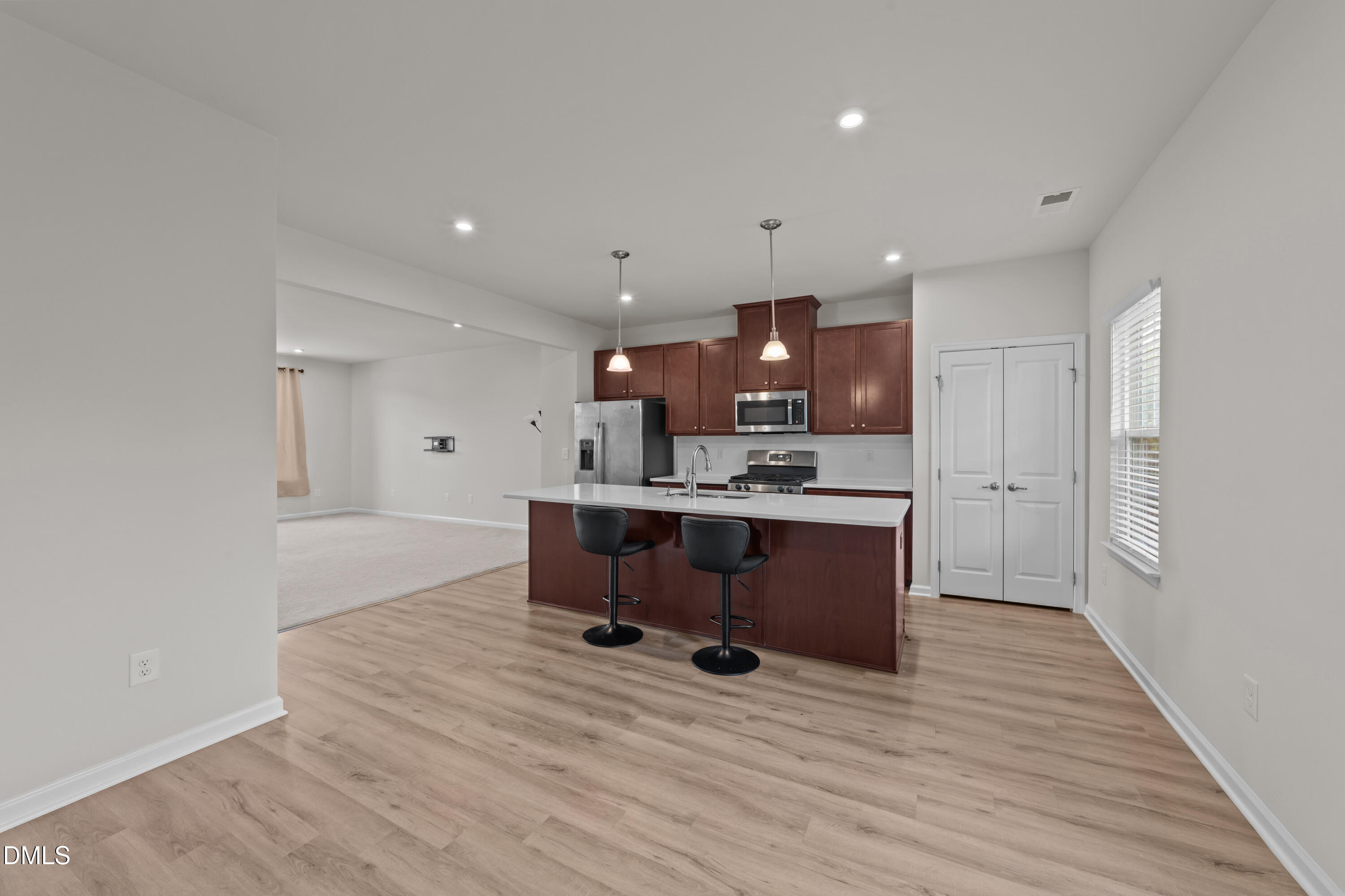 354 Amber Acorn Avenue Raleigh, NC 27603 - Photo 9 of 47 a living room with kitchen furniture and a wooden floor