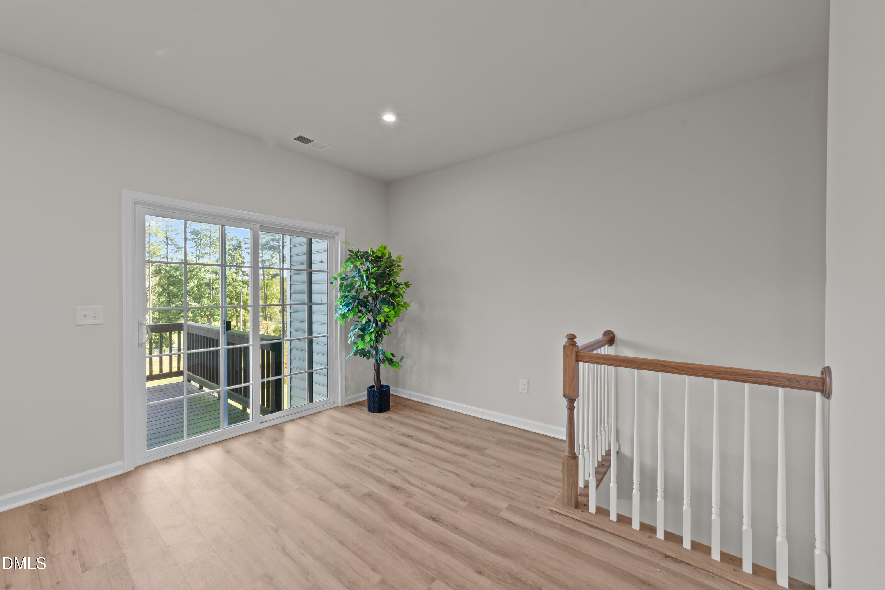 354 Amber Acorn Avenue Raleigh, NC 27603 - Photo 10 of 47 a view of empty room with wooden floor and fan
