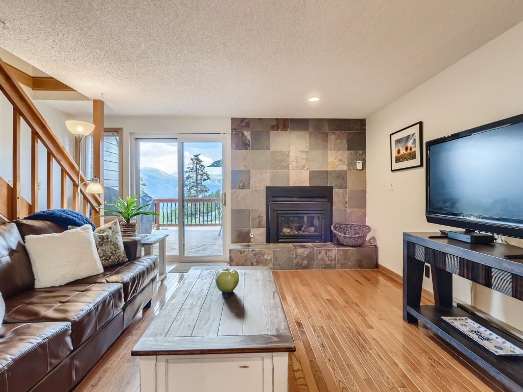 52 Club House Road, Unit 56 Breckenridge, CO 80424 - Photo 1 of 25 a living room with furniture and a flat screen tv