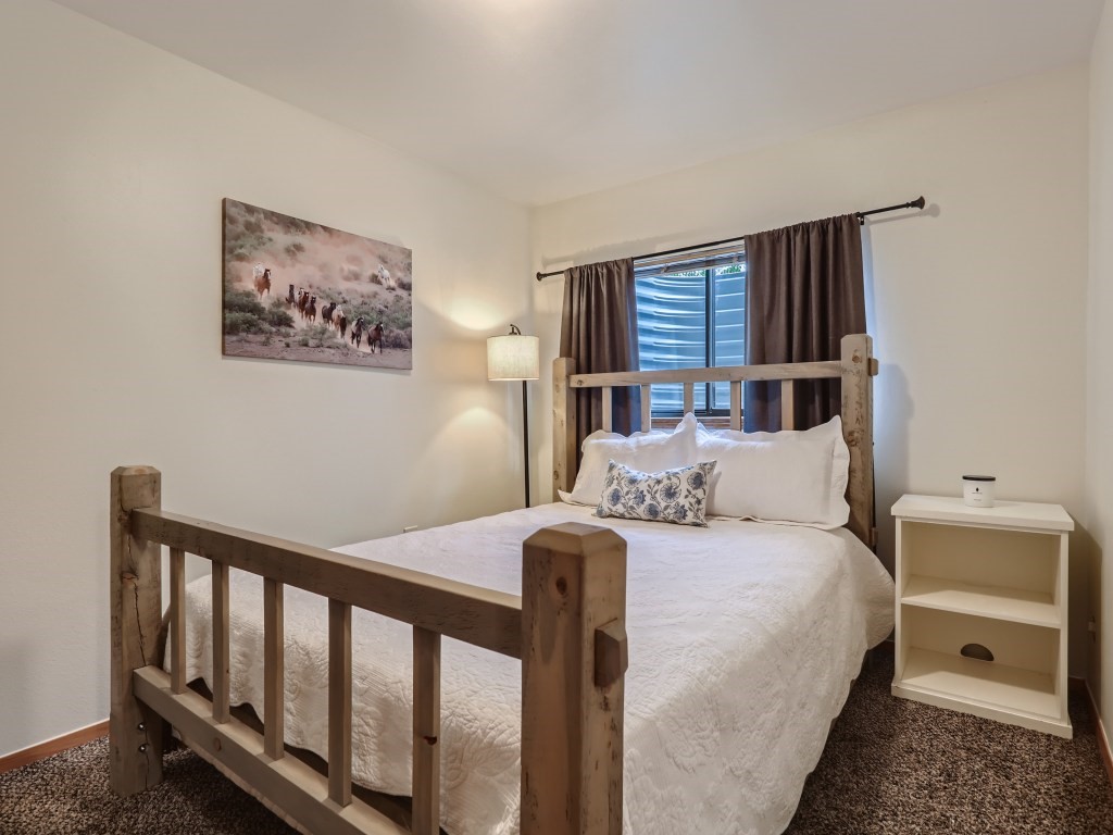 52 Club House Road, Unit 56 Breckenridge, CO 80424 - Photo 17 of 25 a bedroom with a bed and a night stand