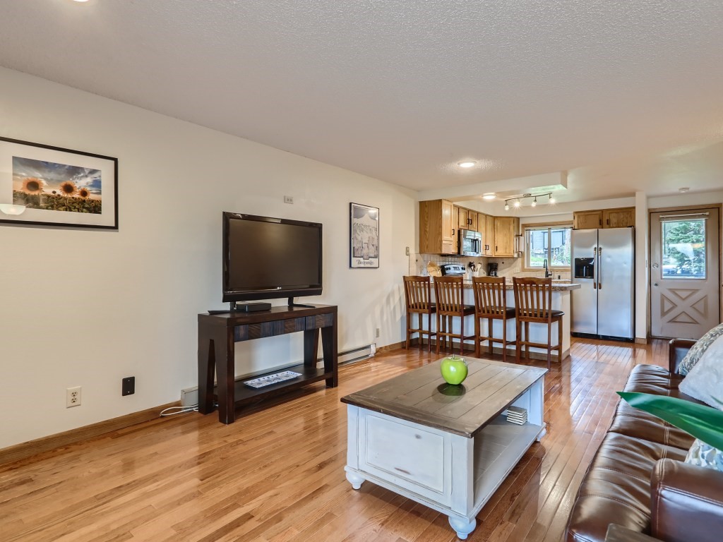 52 Club House Road, Unit 56 Breckenridge, CO 80424 - Photo 3 of 25 a living room with furniture and a flat screen tv