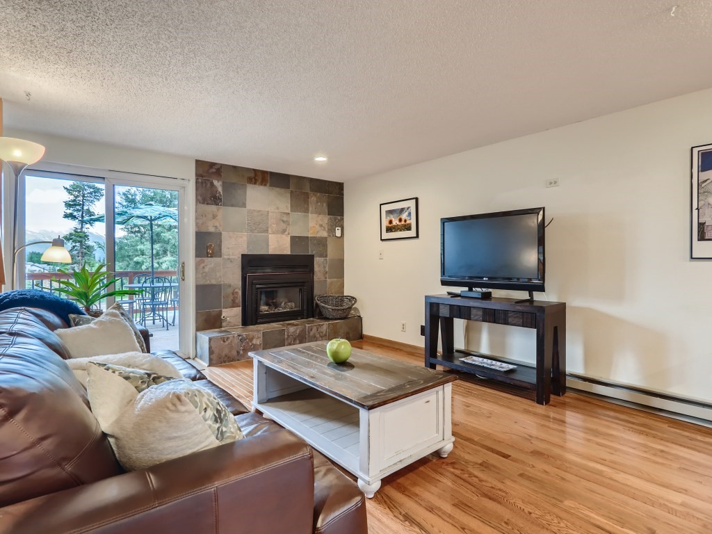 52 Club House Road, Unit 56 Breckenridge, CO 80424 - Photo 4 of 25 a living room with furniture and a flat screen tv