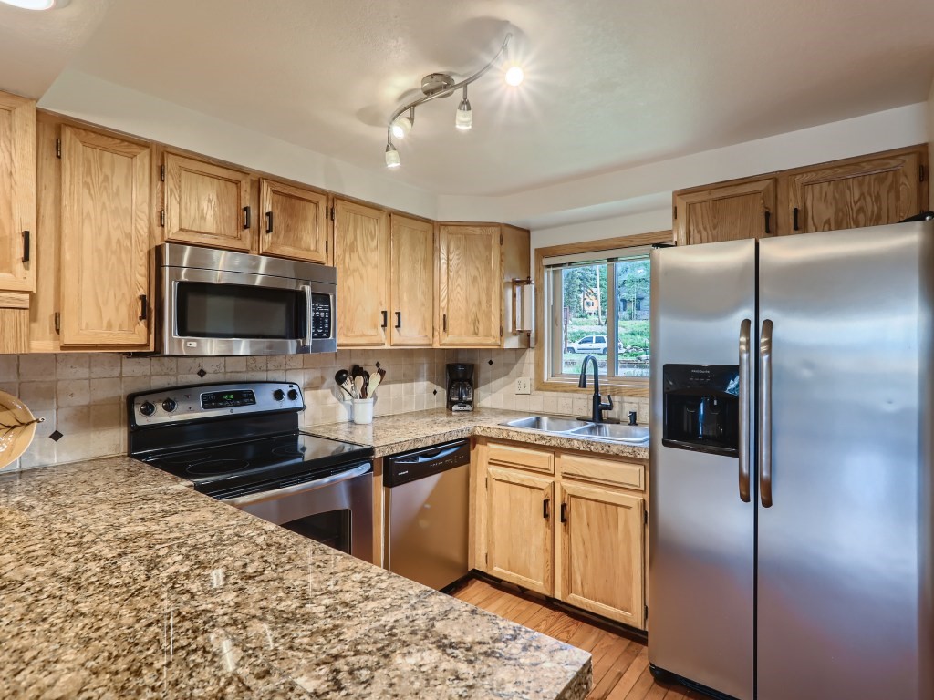52 Club House Road, Unit 56 Breckenridge, CO 80424 - Photo 5 of 25 a kitchen with a sink stainless steel appliances and cabinets