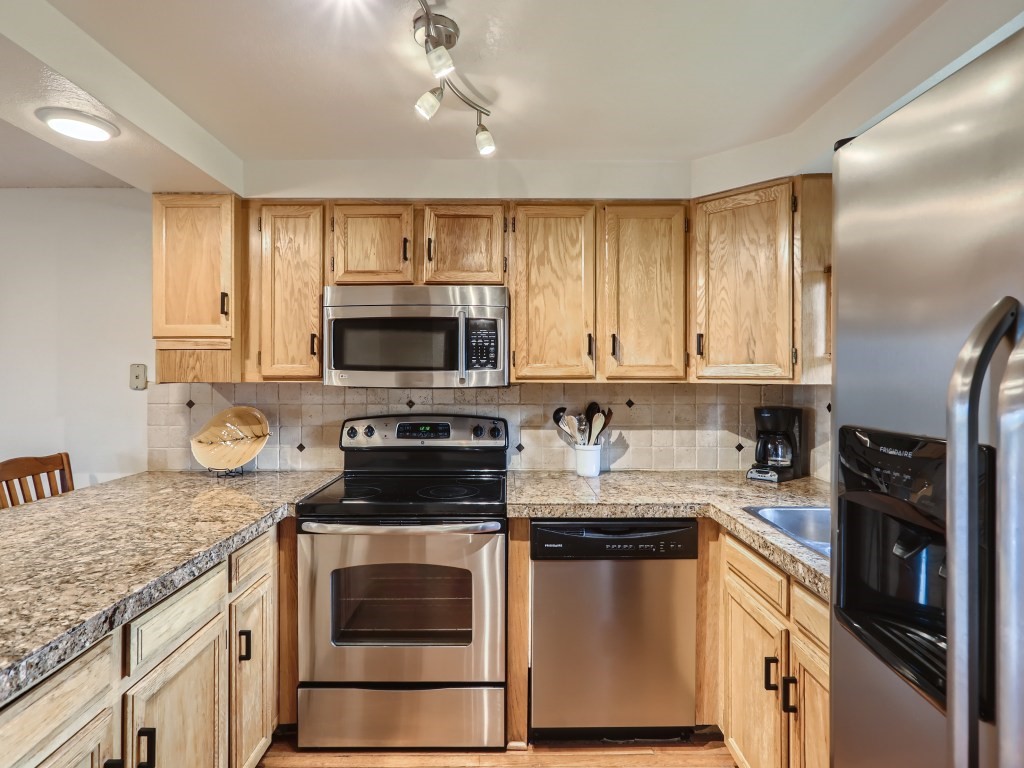 52 Club House Road, Unit 56 Breckenridge, CO 80424 - Photo 6 of 25 a kitchen with granite countertop a stove sink and microwave