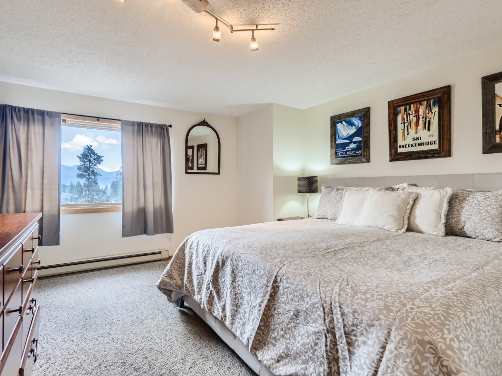 52 Club House Road, Unit 56 Breckenridge, CO 80424 - Photo 10 of 25 a bedroom with a large bed and a window