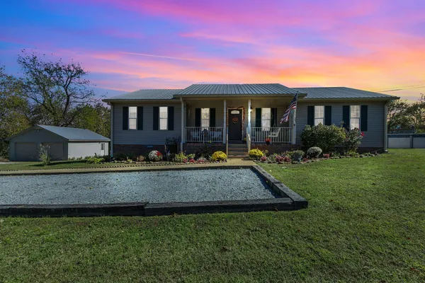 a front view of a house with a yard table and chairs