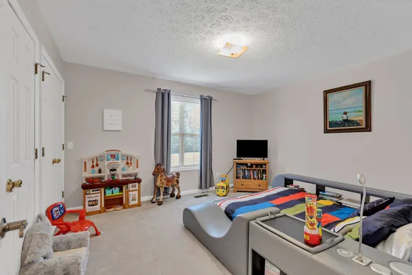 a bedroom with furniture and a window