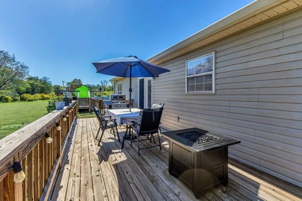a view of outdoor sitting area with furniture and wooden floor