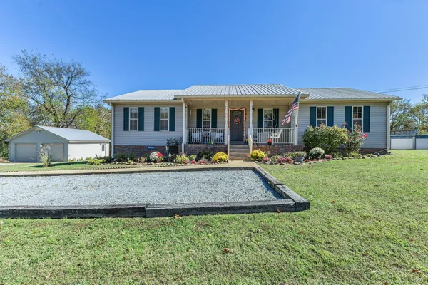 a front view of a house with garden