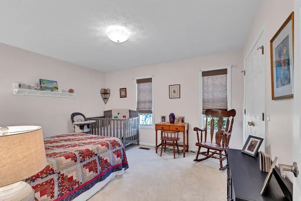 a bedroom with furniture and a chair