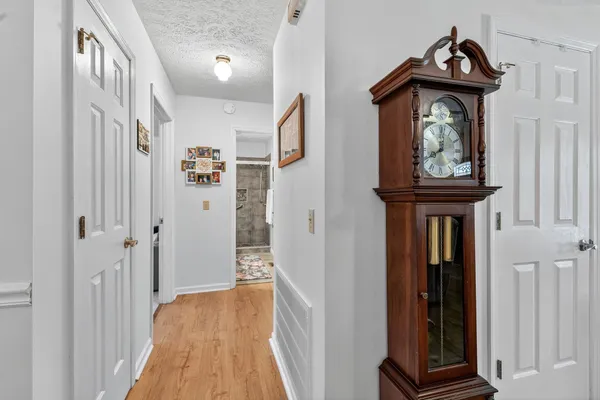 a view of hallway with wooden floor and stairs