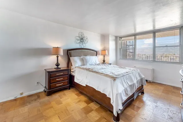 a bed room with a bed and a night stand