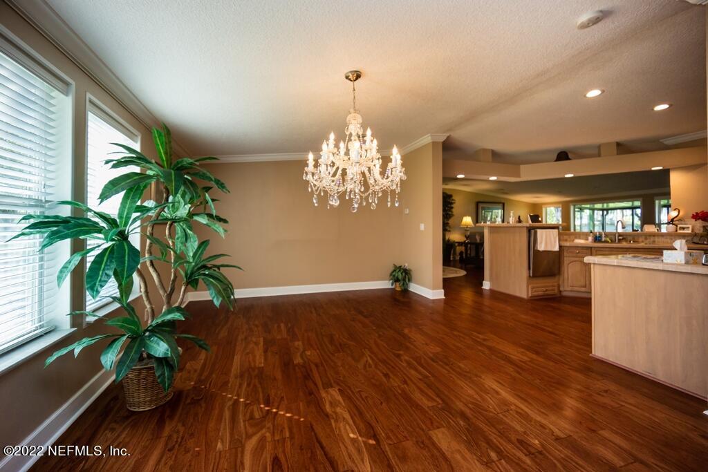 105 South Lake George Drive Georgetown, FL 32139 - Photo 18 of 71 a dining room with furniture a chandelier and wooden floor