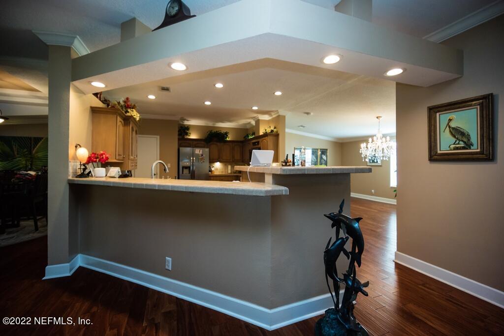 105 South Lake George Drive Georgetown, FL 32139 - Photo 20 of 71 a kitchen with a refrigerator and a wooden floor