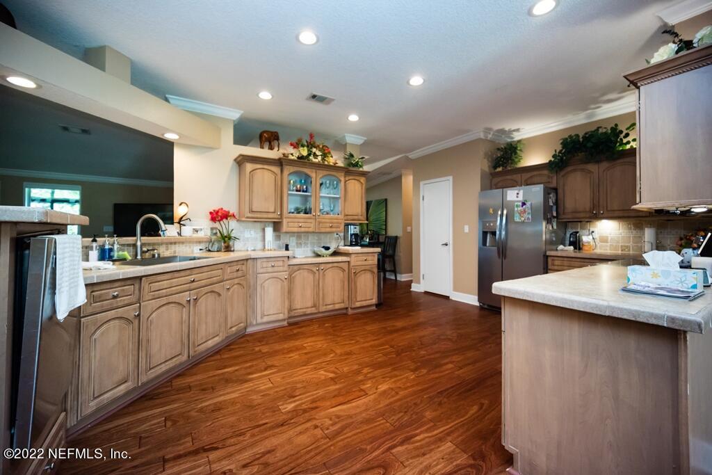 105 South Lake George Drive Georgetown, FL 32139 - Photo 23 of 71 a kitchen with stainless steel appliances kitchen island granite countertop a sink cabinets and wooden floor