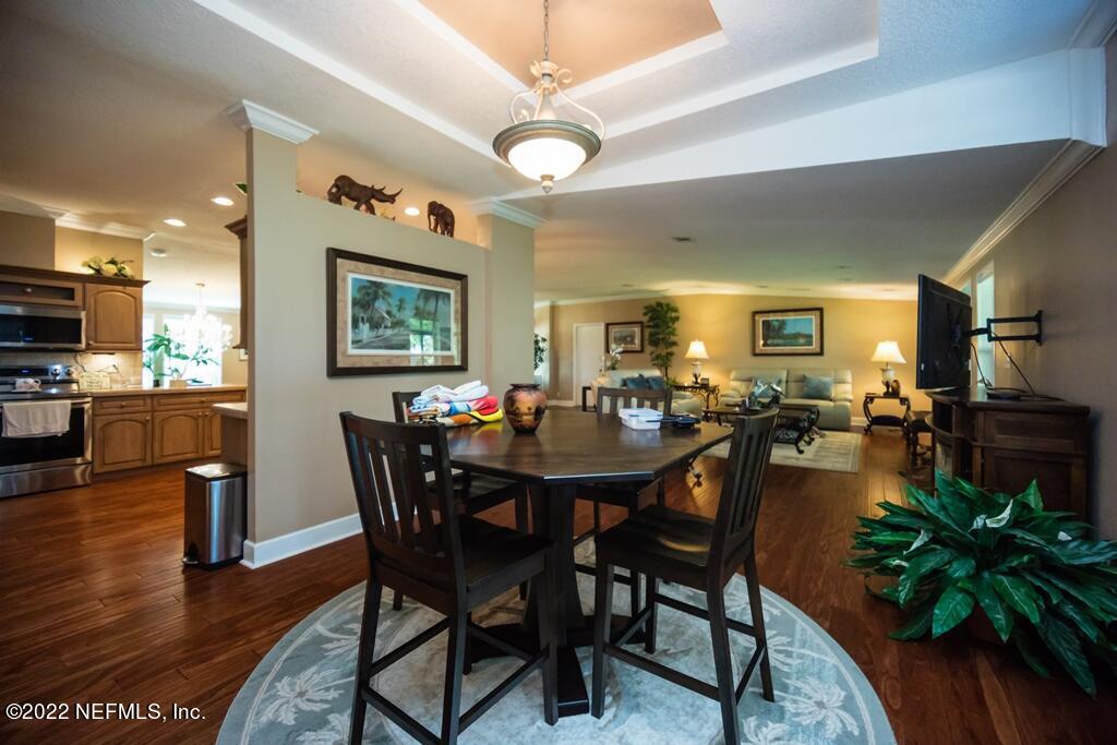 105 South Lake George Drive Georgetown, FL 32139 - Photo 28 of 71 a view of a dining room and livingroom with furniture wooden floor a rug a potted plant and a chandelier