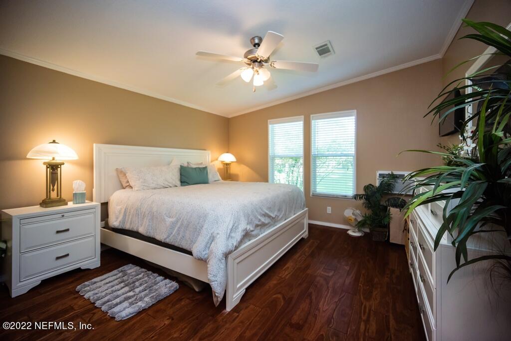 105 South Lake George Drive Georgetown, FL 32139 - Photo 39 of 71 a bedroom with a large bed and a chandelier