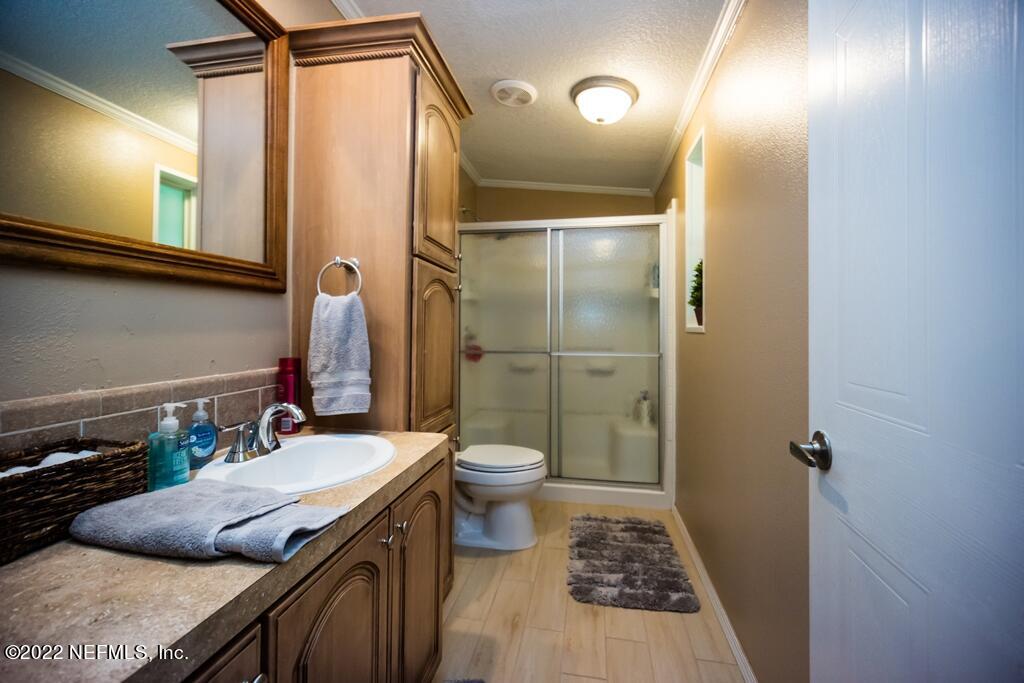 105 South Lake George Drive Georgetown, FL 32139 - Photo 42 of 71 a bathroom with a granite countertop sink toilet and shower