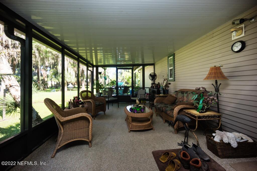 105 South Lake George Drive Georgetown, FL 32139 - Photo 49 of 71 a living room with patio furniture and a potted plant