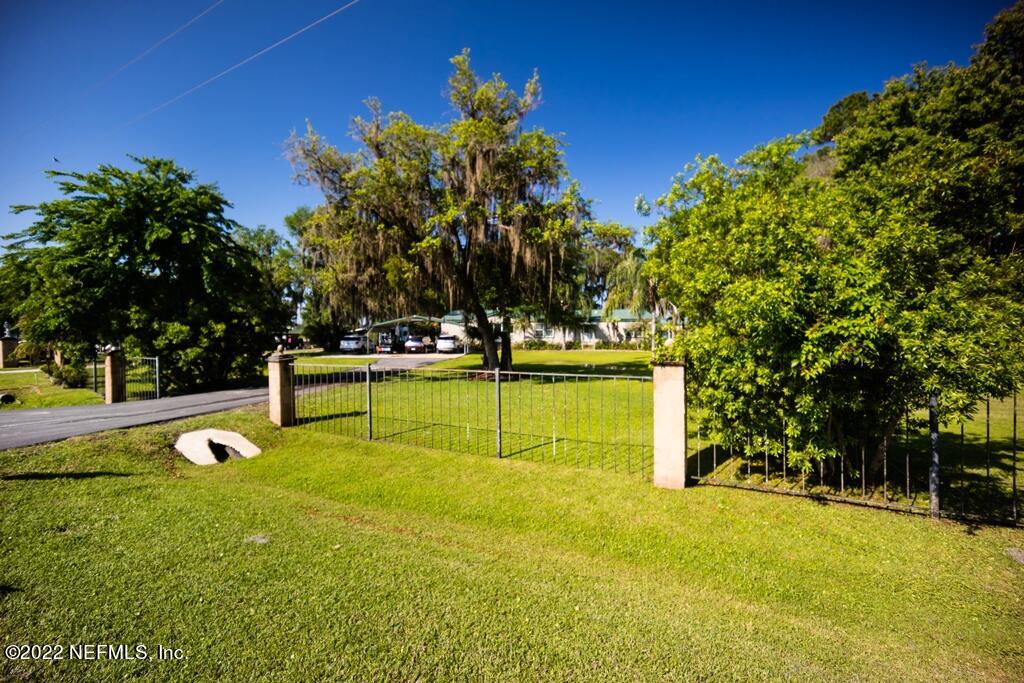 105 South Lake George Drive Georgetown, FL 32139 - Photo 5 of 71 a view of a swimming pool with an outdoor seating and house in the background
