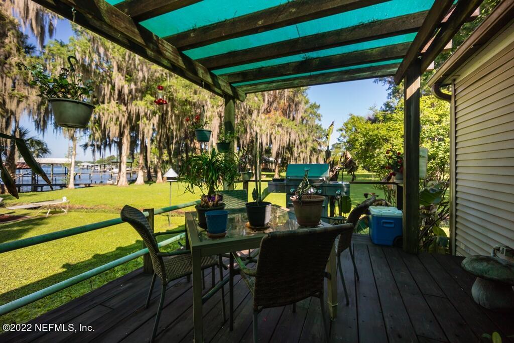 105 South Lake George Drive Georgetown, FL 32139 - Photo 53 of 71 a view of an outdoor dining space with a table and chairs