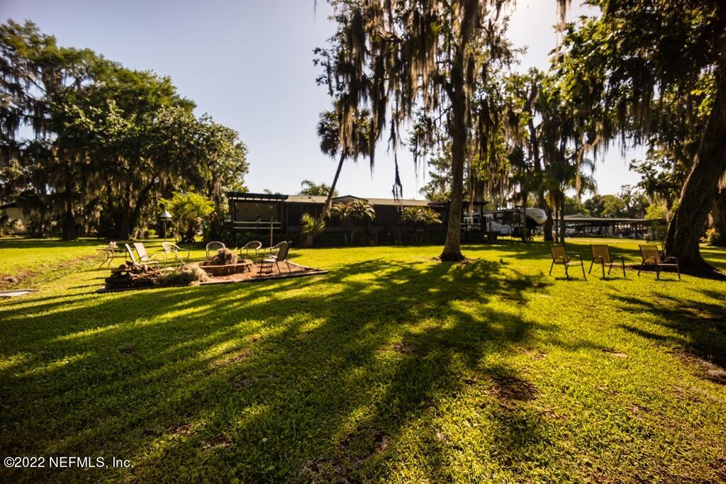 105 South Lake George Drive Georgetown, FL 32139 - Photo 64 of 71 a view of a swimming pool with an outdoor space and seating area
