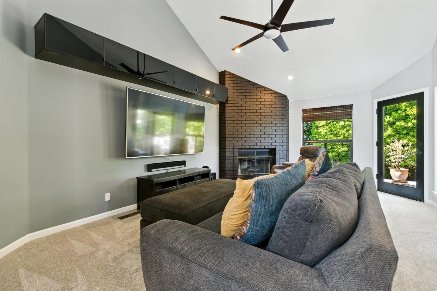 735 Georgetown Place Gilroy, CA 95020 - Photo 11 of 48 a living room with a couch a window and a flat screen tv