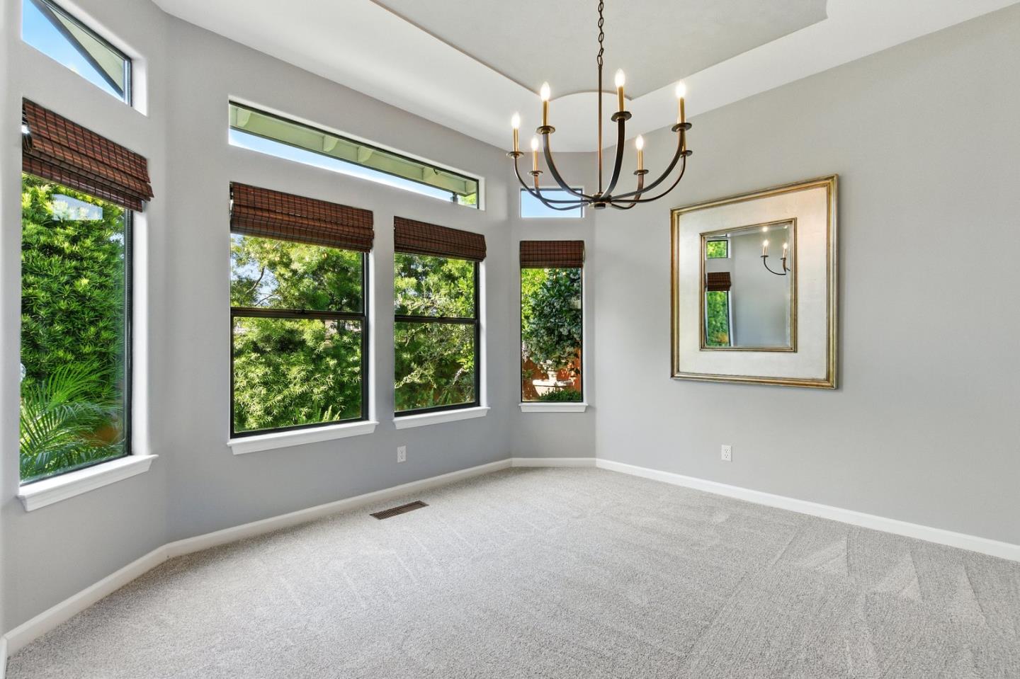 735 Georgetown Place Gilroy, CA 95020 - Photo 15 of 48 a view of an empty room with windows and chandelier