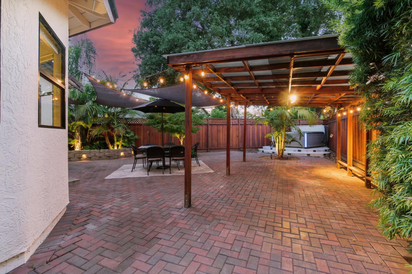 735 Georgetown Place Gilroy, CA 95020 - Photo 36 of 48 a view of patio with a table and chairs under an umbrella with a barbeque