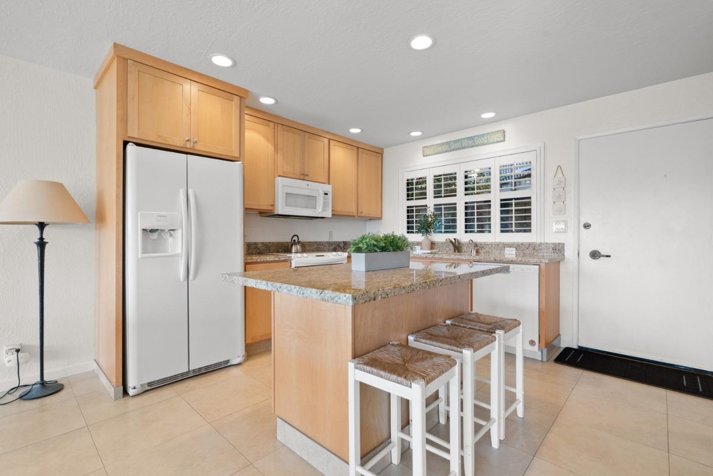 101 Shell Road, Unit 208 Watsonville, CA 95076 - Photo 11 of 26 a kitchen with stainless steel appliances granite countertop a refrigerator and a stove top oven