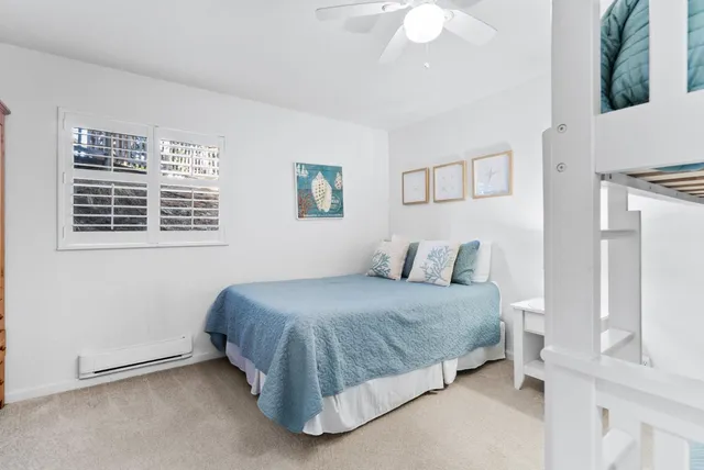 a spacious bedroom with a bed and a chandelier