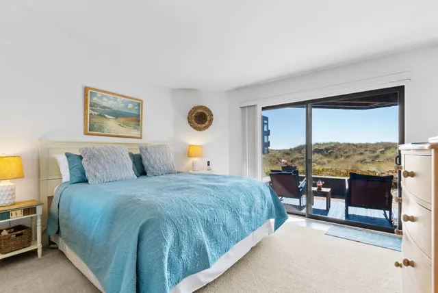 a bedroom with a bed a table and chair