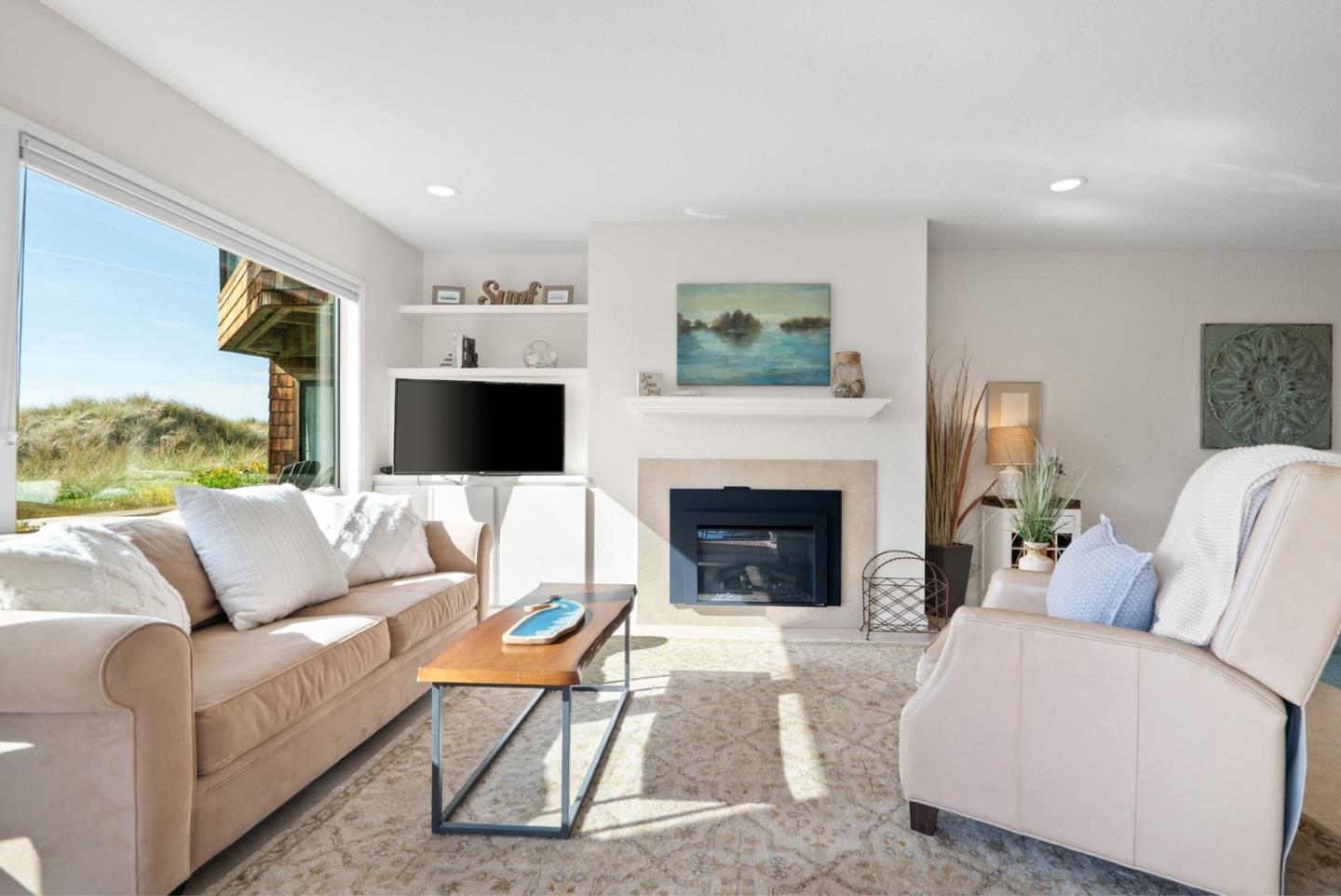 101 Shell Road, Unit 208 Watsonville, CA 95076 - Photo 24 of 26 a living room with furniture a flat screen tv and a fireplace