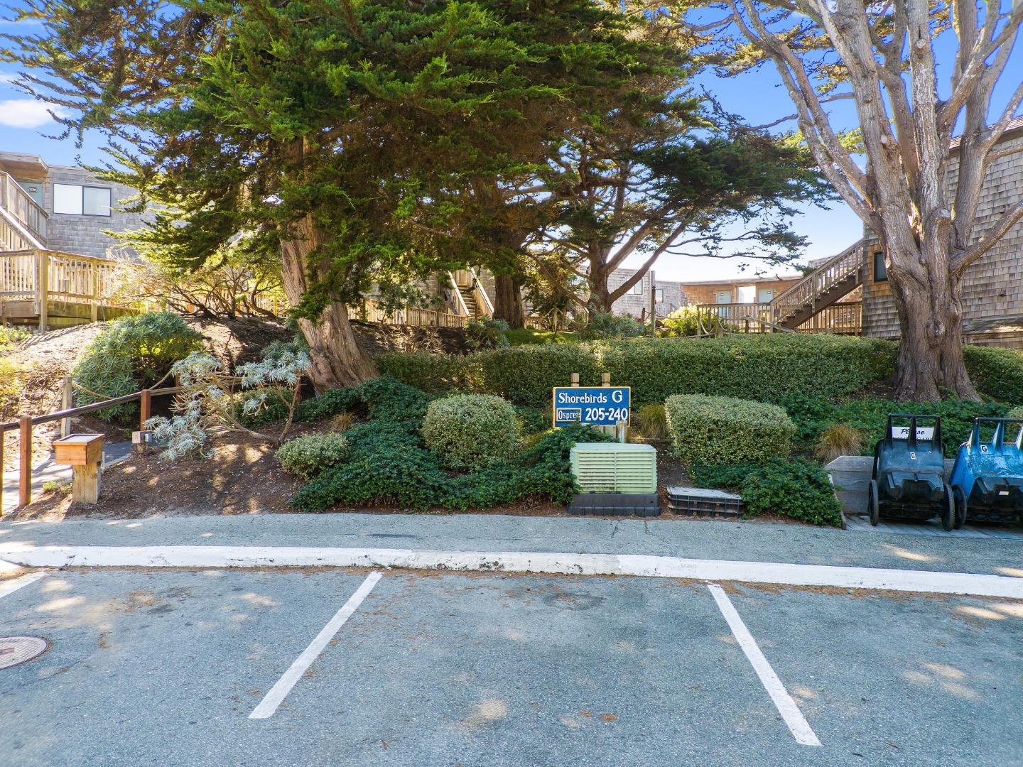 101 Shell Road, Unit 208 Watsonville, CA 95076 - Photo 26 of 30 a view of a garden with a bench in front of a house